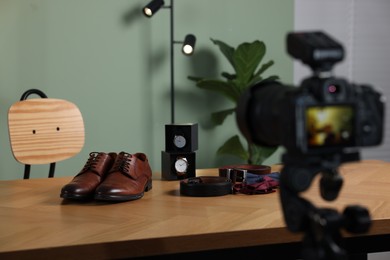 Photo of Beauty blogger's workplace. Men's accessories on table indoors