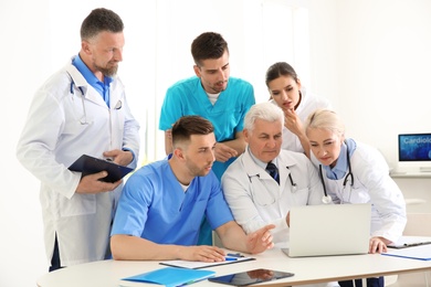 Photo of Group of doctors attending meeting in clinic. Cardiology conference