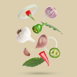 Image of Different spices falling on dark beige background