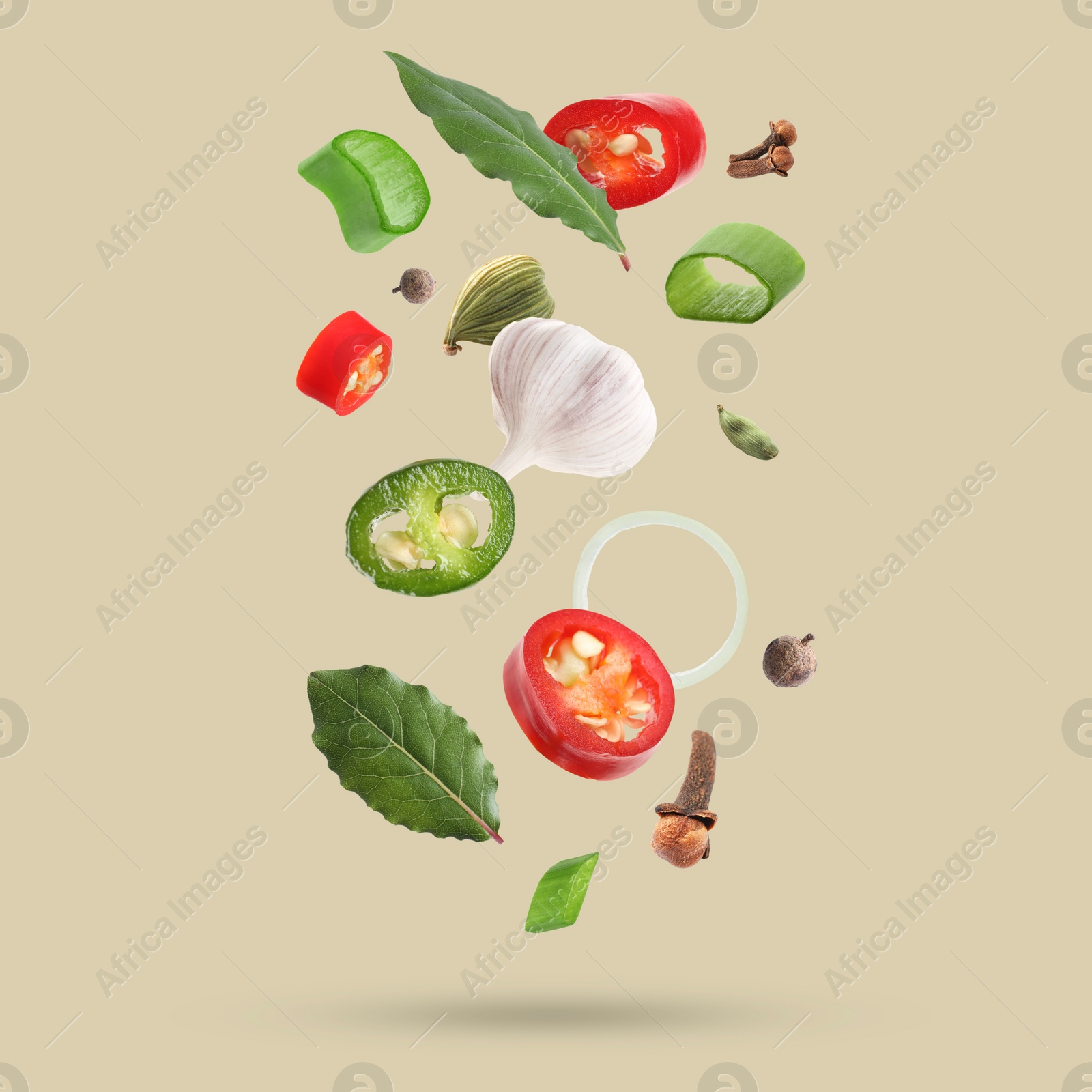 Image of Different spices falling on dark beige background