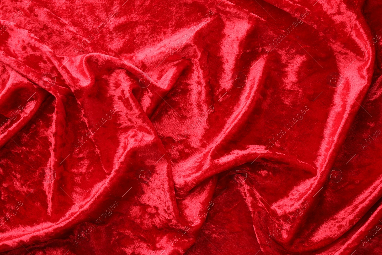 Photo of Texture of crumpled red velvet fabric as background, top view