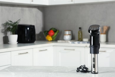 Photo of Thermal immersion circulator on table in kitchen, space for text. Sous vide cooking