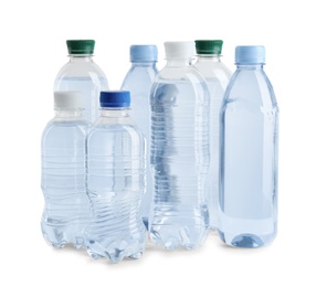 Set of different plastic bottles with water on white background