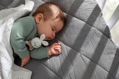 Cute little baby sleeping in crib at home. Space for text