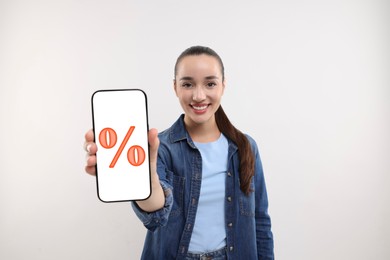 Image of Discount, offer, sale. Woman showing mobile phone with percent sign on screen, white background