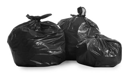 Photo of Black trash bags full of garbage on white background