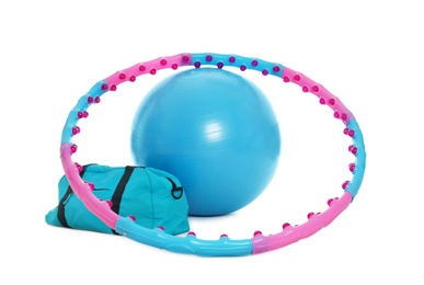 Hula hoop, fitness ball and gym bag on white background