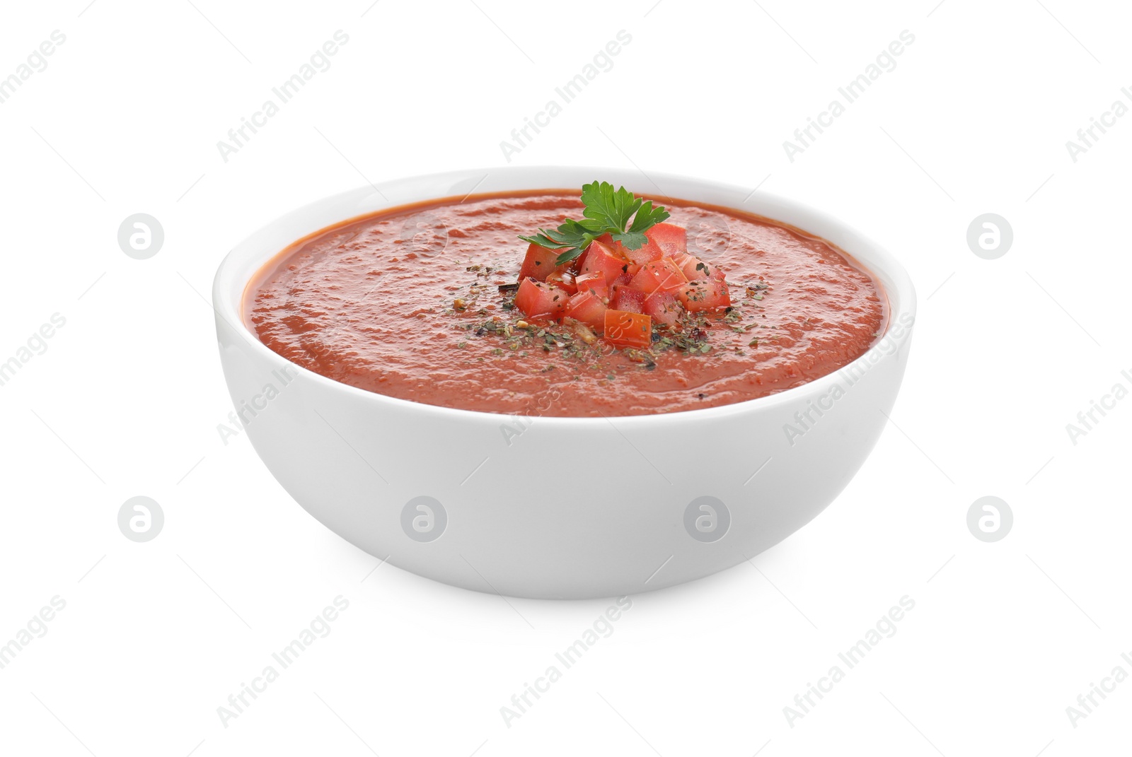 Photo of Delicious tomato cream soup with spices in bowl isolated on white