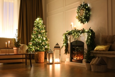 Beautiful room interior with fireplace and Christmas decor in evening