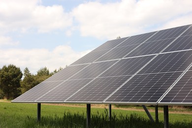 Solar panels in field on sunny day. Alternative energy