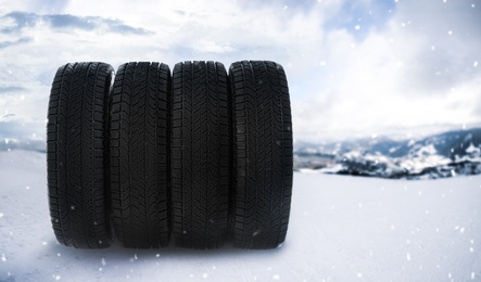 Set of new winter tires outdoors on snow 