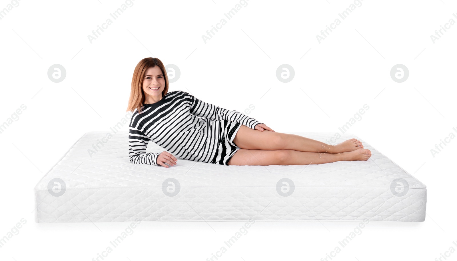 Photo of Woman lying on mattress against white background