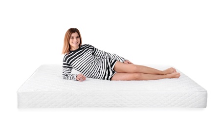 Photo of Woman lying on mattress against white background