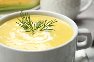 Delicious creamy corn soup on table, closeup