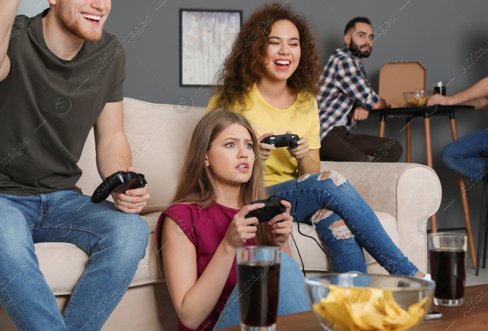 Photo of Emotional friends playing video games at home