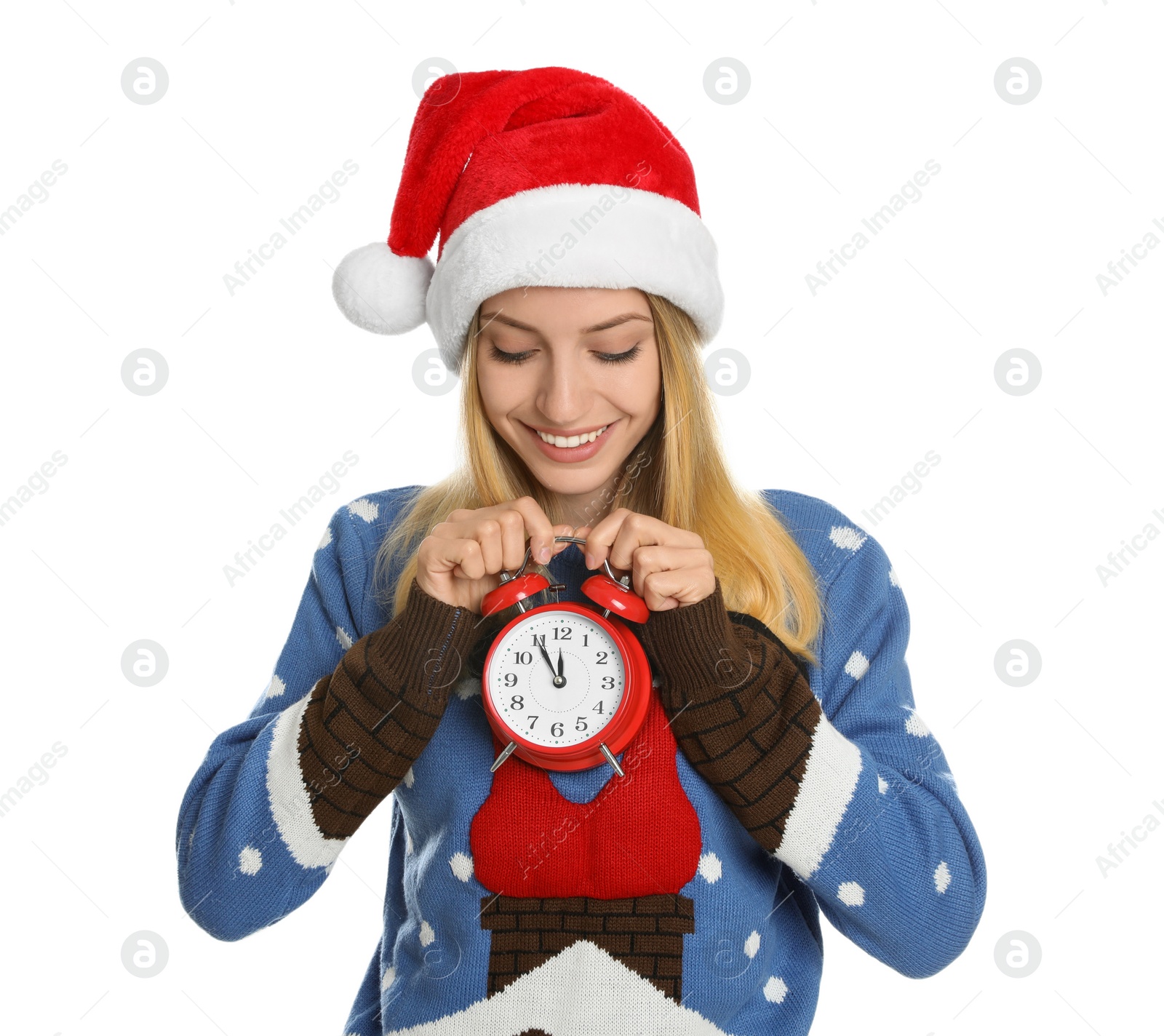 Photo of Woman in Santa hat with alarm clock on white background. New Year countdown