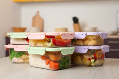 Boxes with prepared meals on table against blurred background