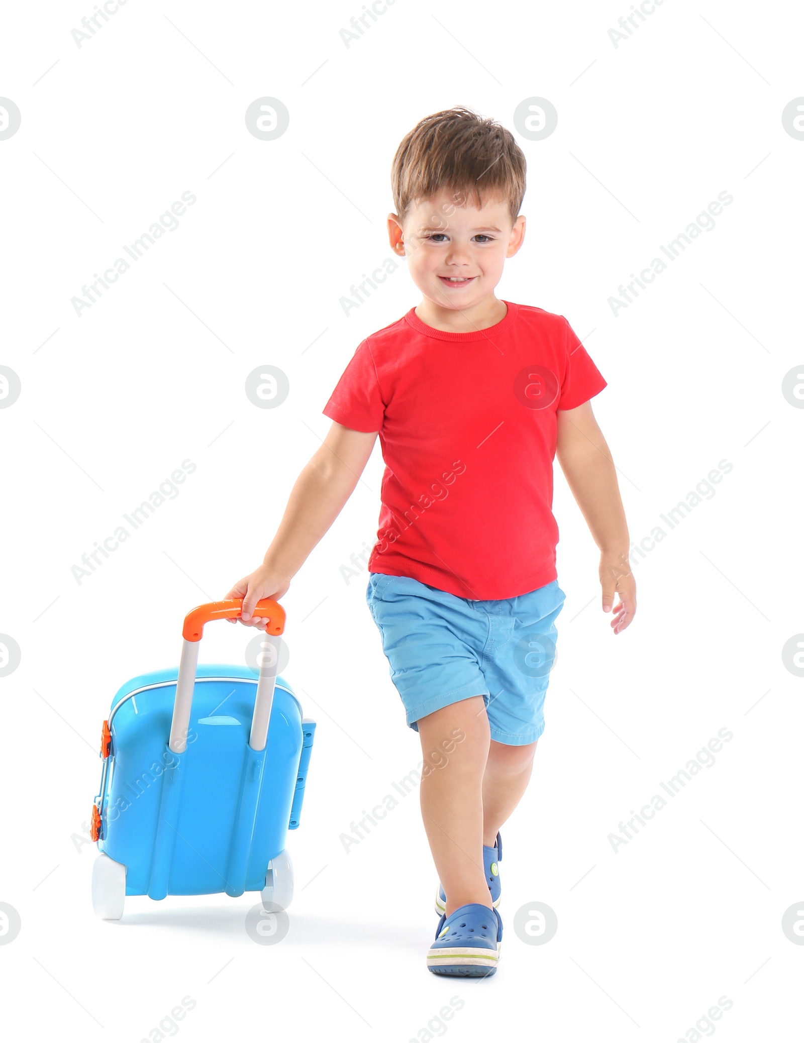 Photo of Cute little boy with blue suitcase on white background