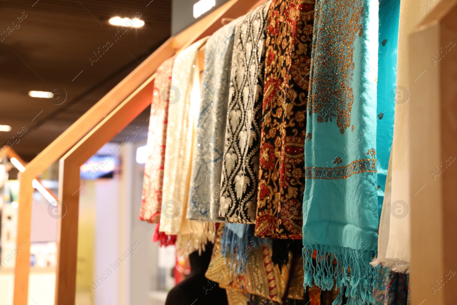Photo of DUBAI, UNITED ARAB EMIRATES - NOVEMBER 04, 2018: Different scarves on rack in store