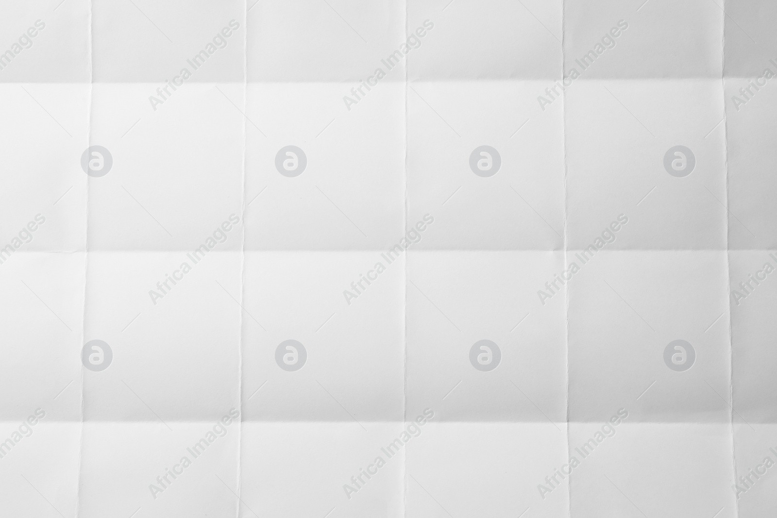 Photo of Blank sheet of paper with creases as background, closeup