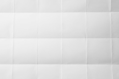 Photo of Blank sheet of paper with creases as background, closeup