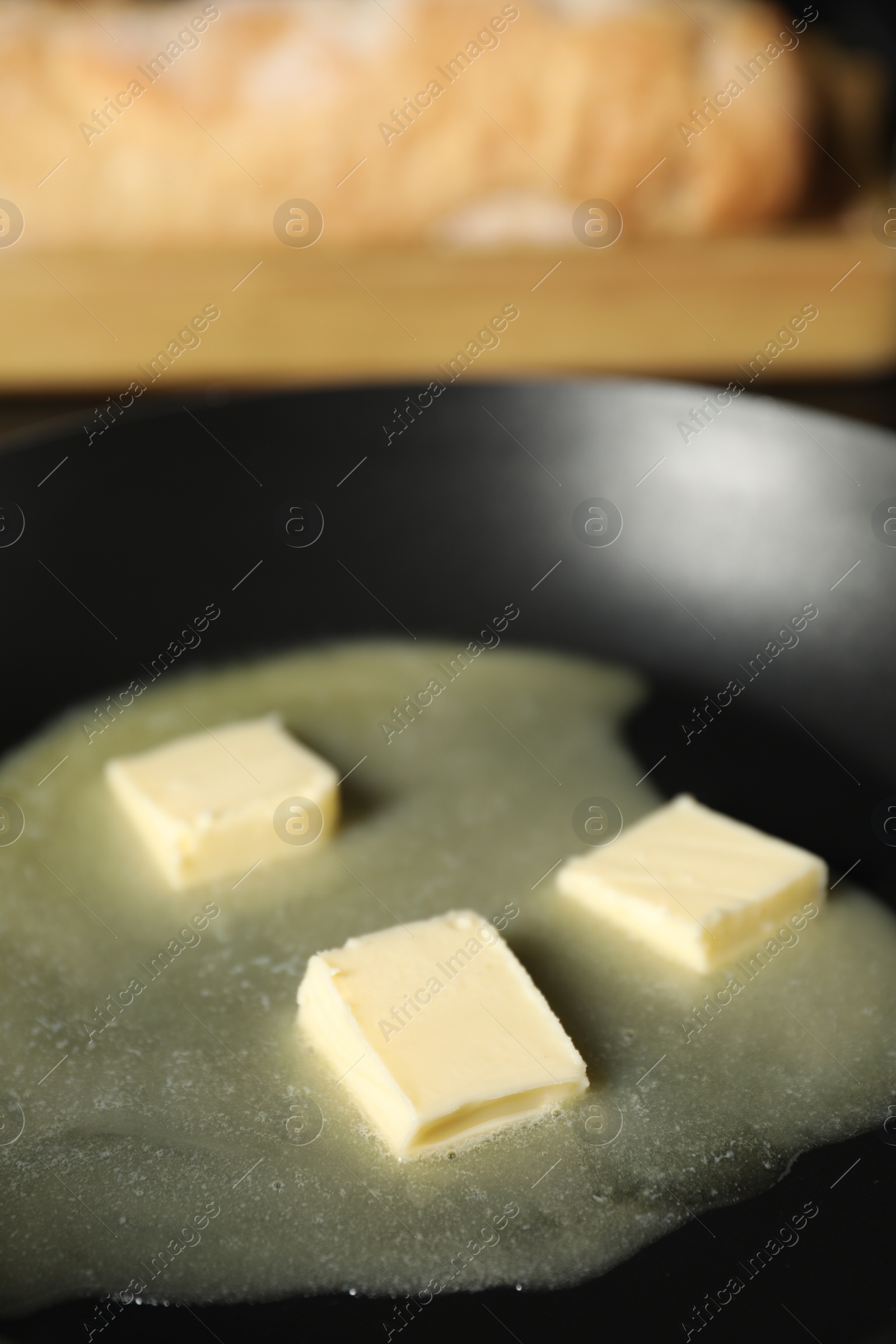 Photo of Melting butter in frying pan, closeup view