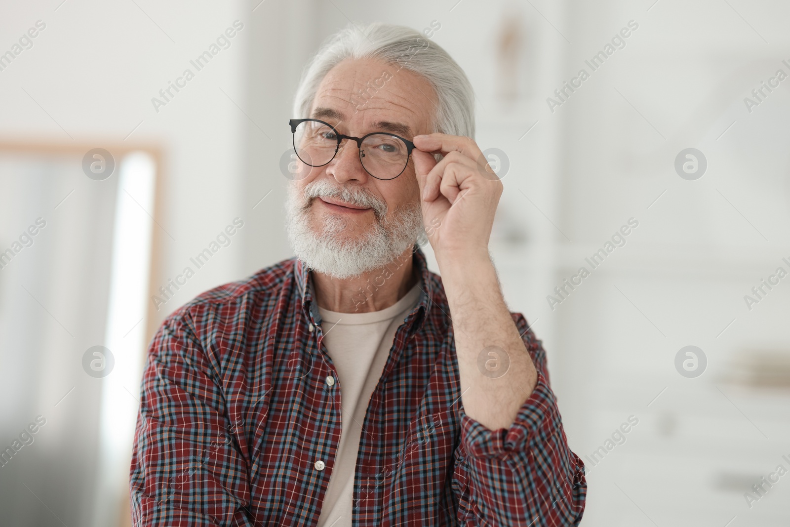 Photo of Portrait of happy grandpa with glasses indoors