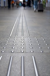 Photo of Floor tiles with tactile ground surface indicators, closeup view