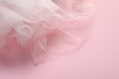 Beautiful white tulle fabric on pink background