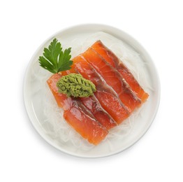 Photo of Sashimi set (salmon slices) with parsley, vasabi and funchosa isolated on white, top view