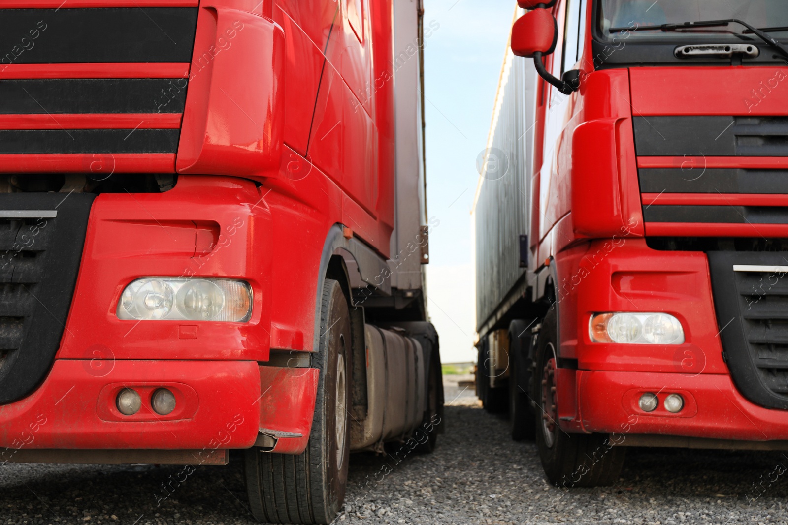 Photo of Modern red trucks parked on road, closeup