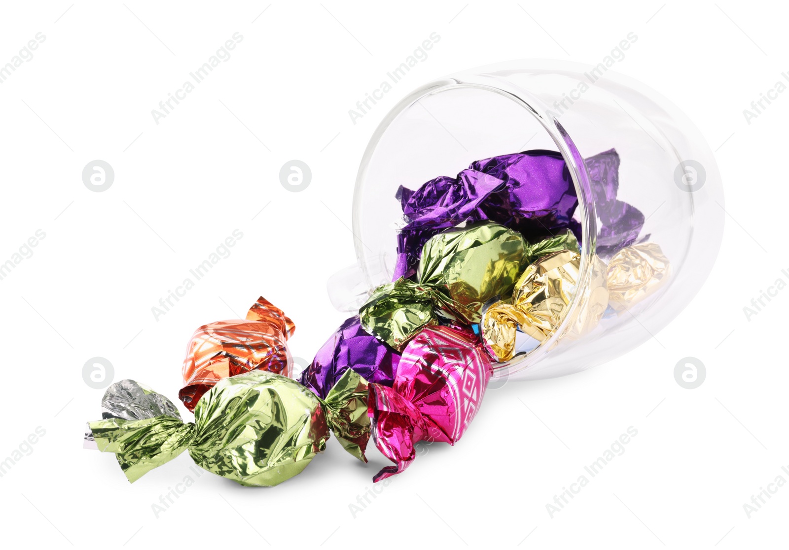 Photo of Glass cup with candies in colorful wrappers isolated on white