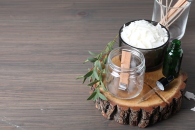 Photo of Composition with homemade candle ingredients on wooden table, space for text