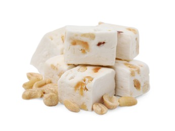 Photo of Pieces of delicious nougat and nuts on white background