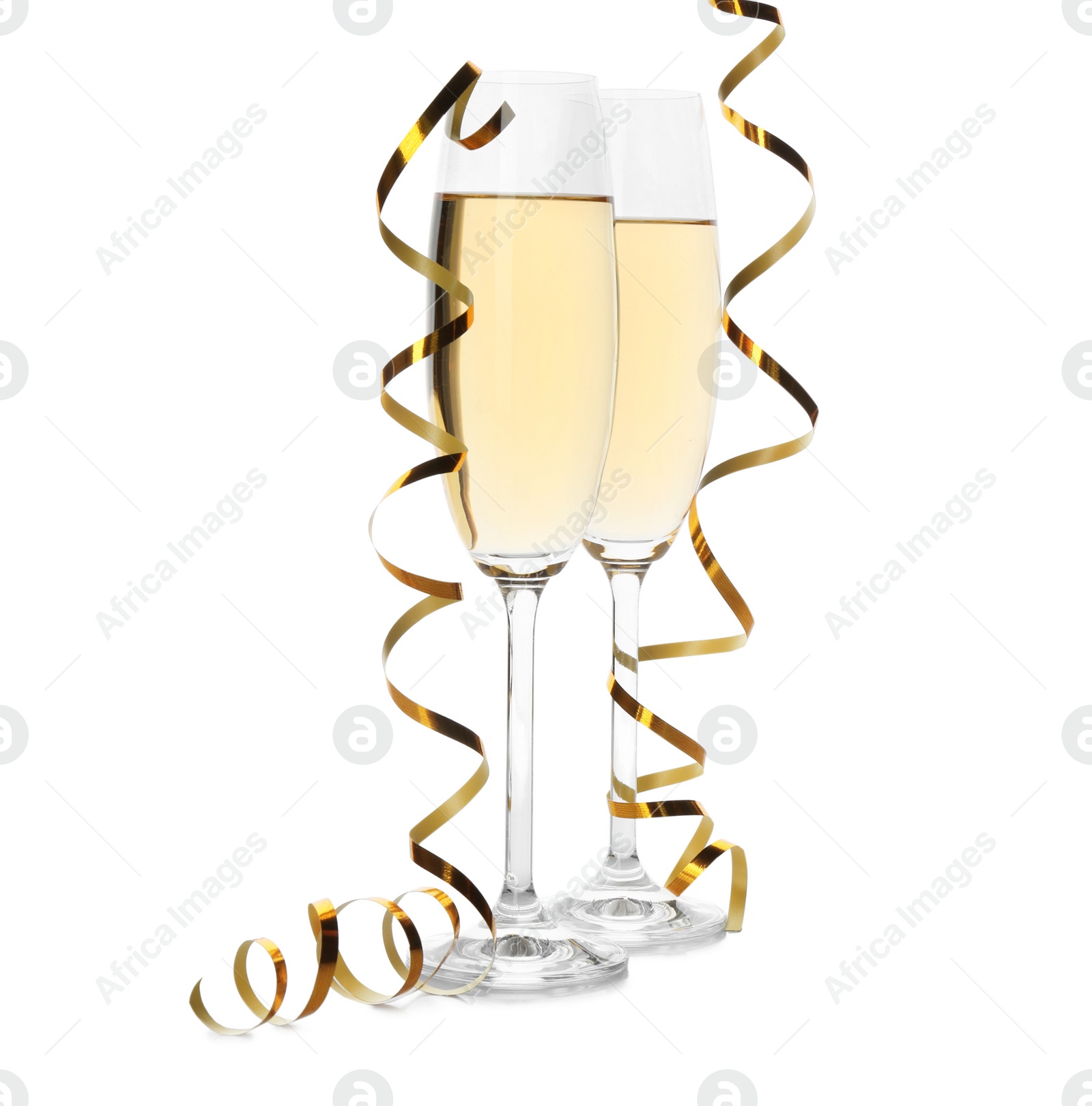 Photo of Glasses of champagne and streamers on white background