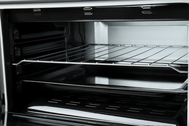 Photo of Open electric oven, closeup view. Cooking appliance