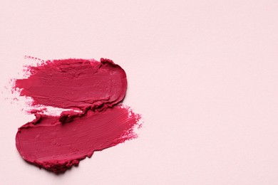 Photo of Smears of bright lipstick on light background, top view. Space for text