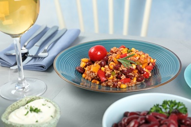 Photo of Plate with tasty chili con carne served on gray table