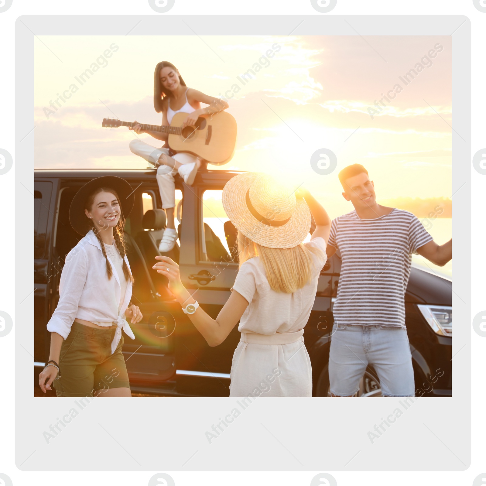 Image of Paper photo. Happy friends having fun near car outdoors at sunset 