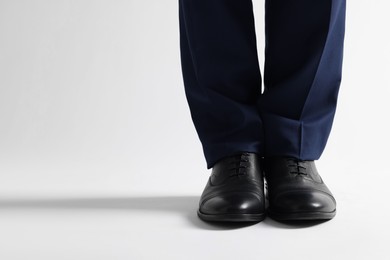 Businessman in leather shoes on white background, closeup