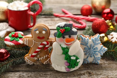 Photo of Delicious homemade Christmas cookies and festive decor on wooden table