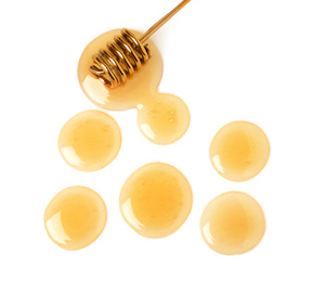 Drops of honey and dipper on white background, top view