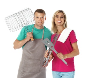 Photo of Happy couple with barbecue utensils on white background