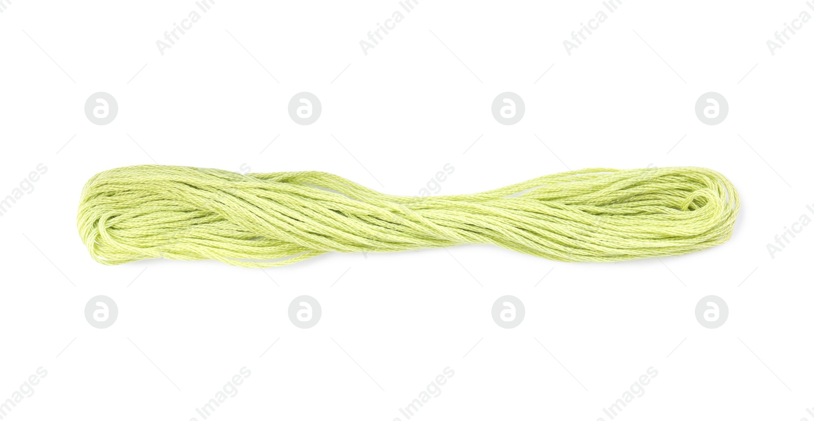 Photo of Bright yellowish green embroidery thread on white background