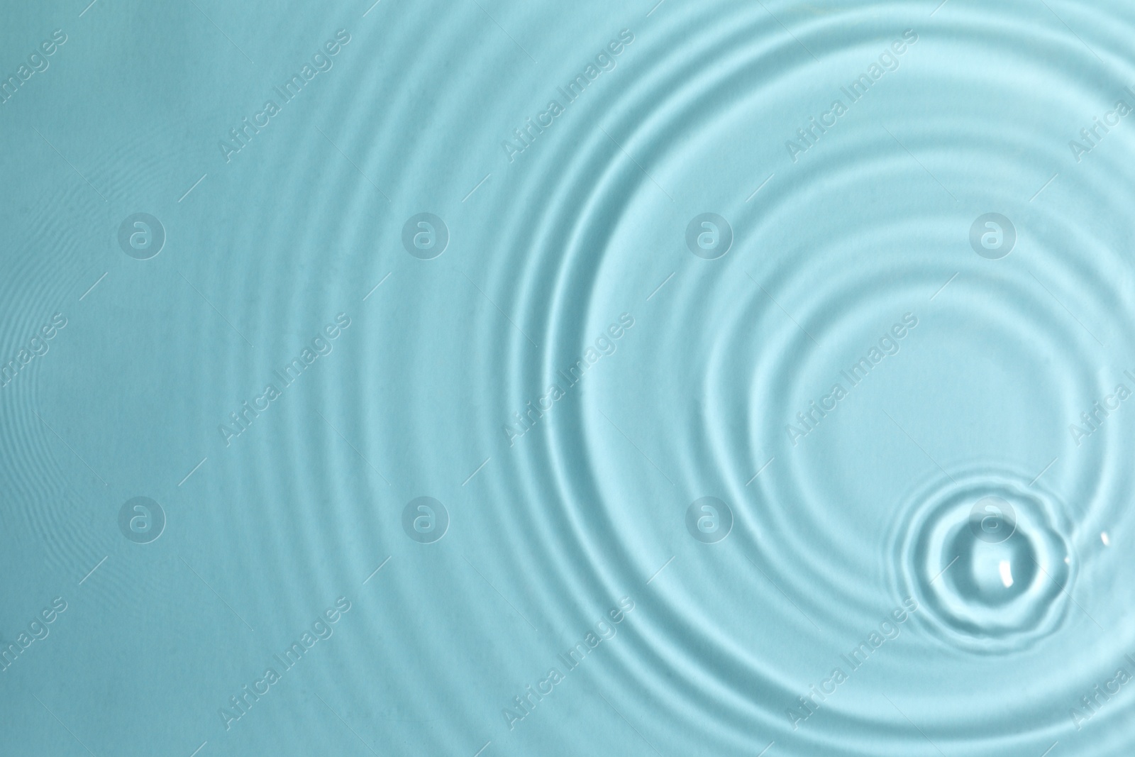 Photo of Closeup view of water with circles on turquoise background