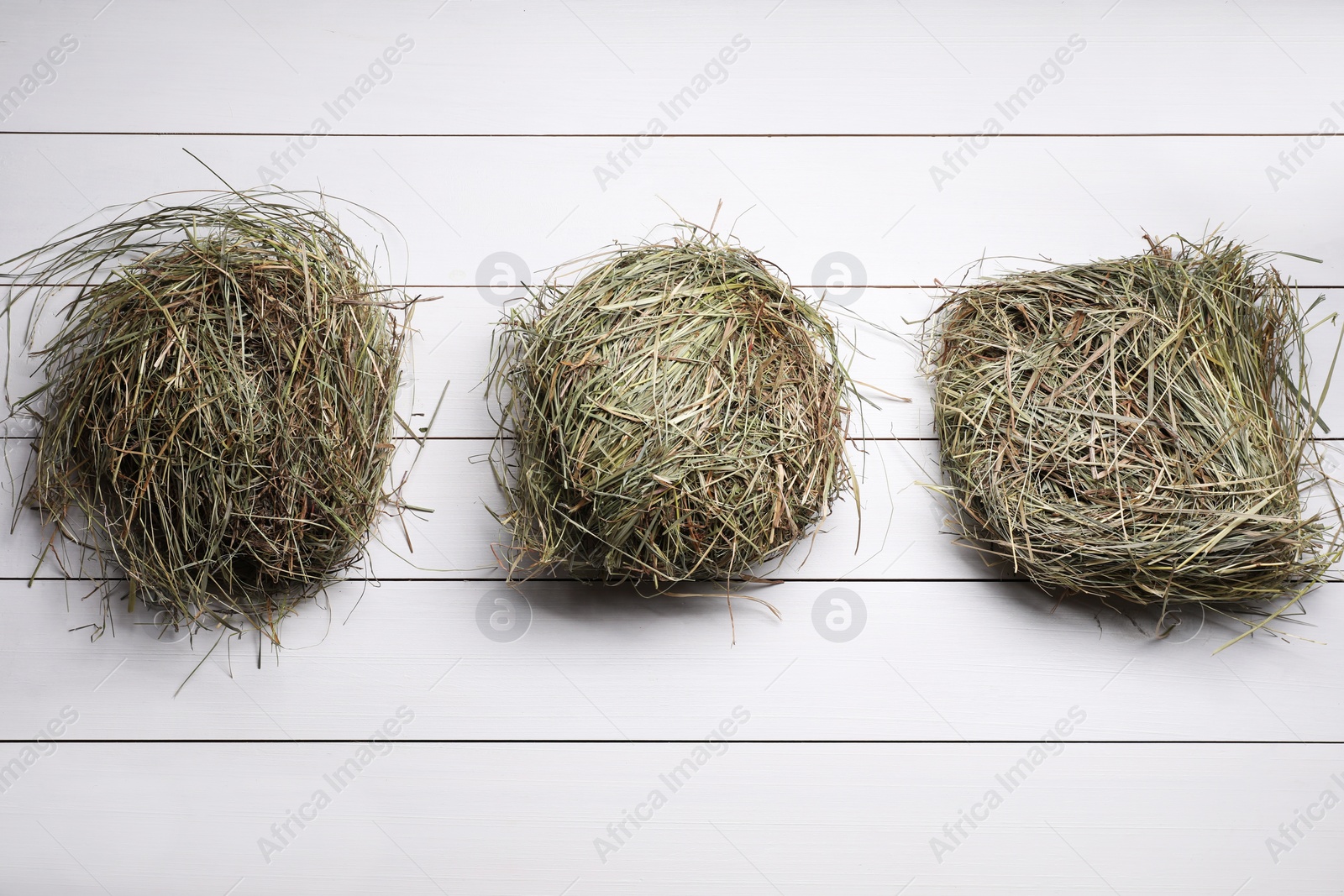 Photo of Dried hay on white wooden table, top view