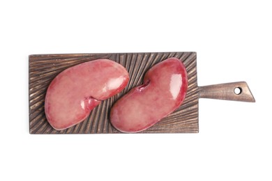 Photo of Wooden board with fresh raw pork kidneys on white background, top view