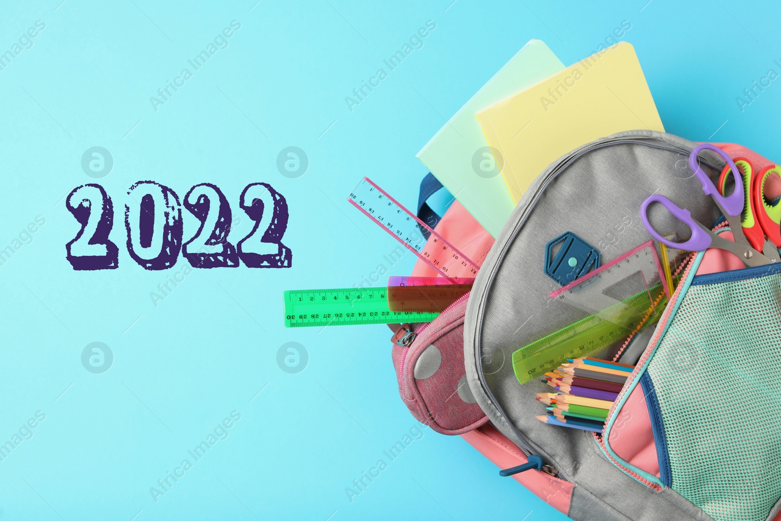 Image of Back to school 2022. Stylish backpack with different stationery on turquoise background, top view