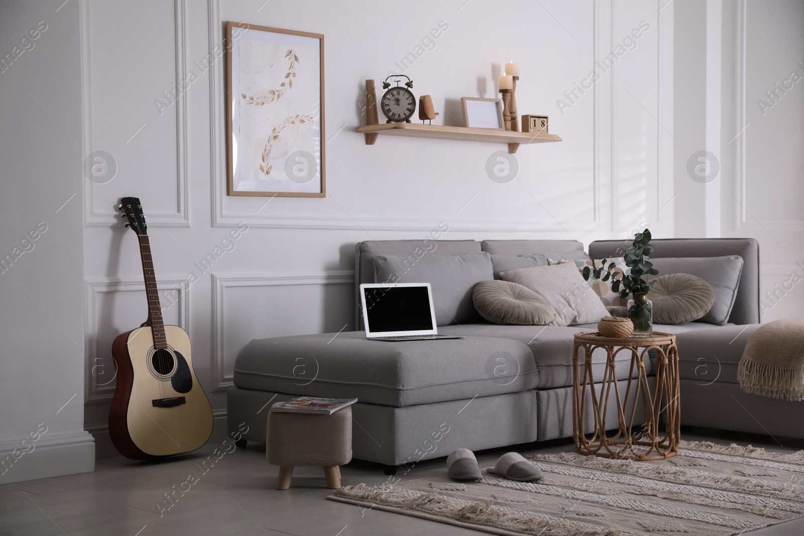 Photo of Living room with comfortable grey sofa and stylish interior elements