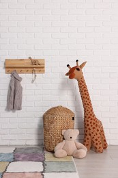 Beautiful children's room with white brick wall and toys. Interior design